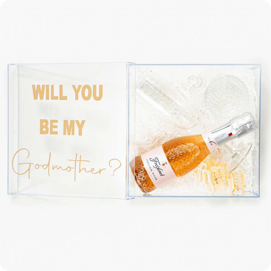 Godmother proposal box with message and celebratory items.