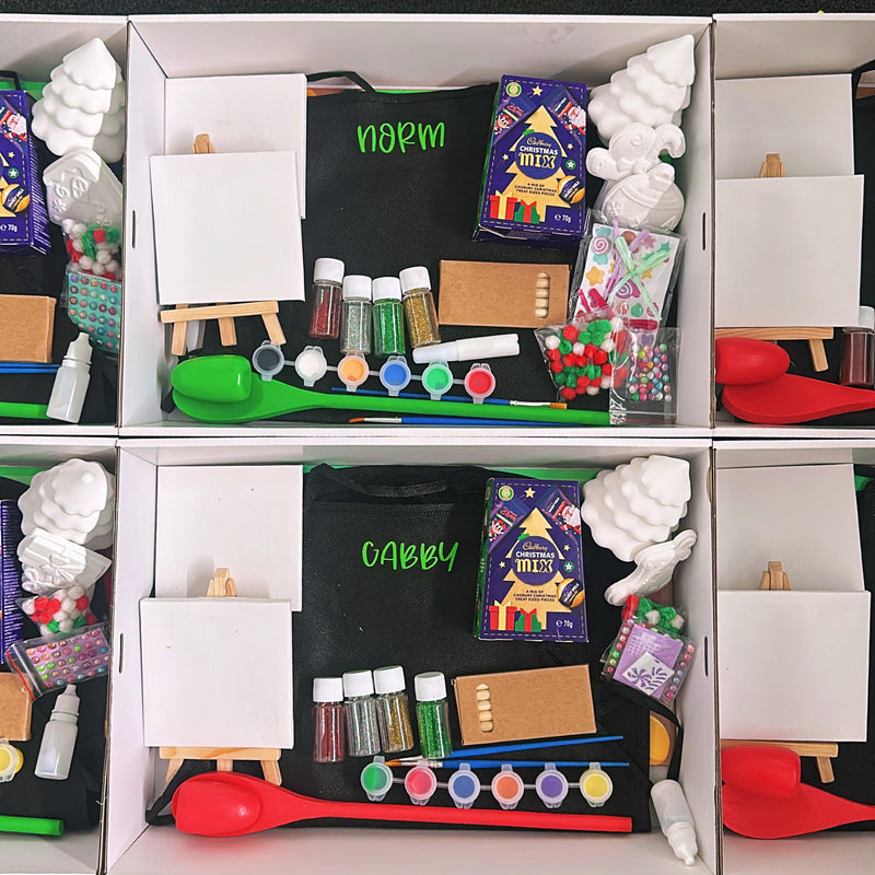 Kids Activities and Crafts Christmas Gift Box showing paints, canvases, apron, glitter and chocolate treats.